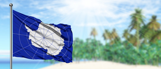Waving Antarctica flag in the sunny blue sky with summer beach background. Vacation theme, holiday concept.