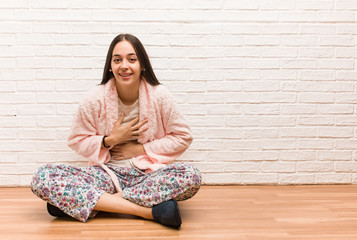 Young woman wearing pajama laughing and having fun