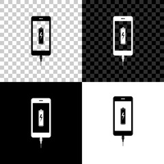 Smartphone battery charge icon isolated on black, white and transparent background. Phone with a low battery charge and with USB connection. Vector Illustration