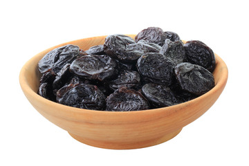 dried plums in wooden cup isolated on white background