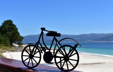 Beach with black iron bicycle. Galicia, Spain.