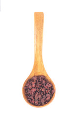 dried barberry in wooden spoon isolated