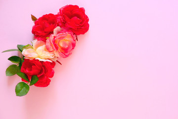 Fototapeta na wymiar Red flowers pink on pink background. Women's day. Place for your text and advertising.