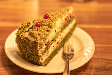 Spinach layer cake with white cheese cream, green spinach and decorated with cranberries