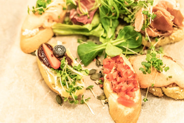 Italian antipasti wine snacks set with Shallow depth of focus over dark grunge background