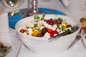 Greek salad on a served table for a festive dinner