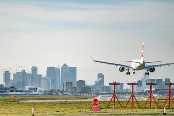Foto op Canvas London, UK - 17, February 2019: Helvetic Airways airline based in Zurich Kloten, Switzerland. Aircraft type Embraer ERJ-190 Landing at London City Airport. © CupOfSpring
