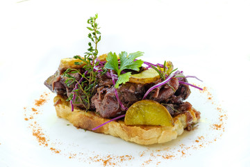 close up of a gourmet slow braised beef in red wine sauce  with roast potatoes, vegetable and mixed herbs on top of a slice of artisanal homemade sourdough bread in a white plate , natural light 