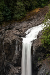 Fototapeta na wymiar The top of the majestic Elk Falls as it crashes over the top on the Campbell River, Vancouver Island, Canada, on a long exposure to create motion blur to the falling water nobody in the iamge