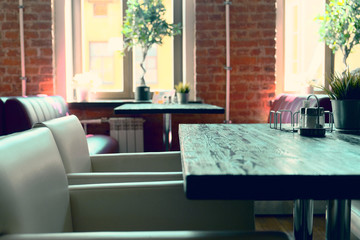 Interior cafe tables and chairs. Blurred background made with viitaniementie, background blur cafe with bokeh.
