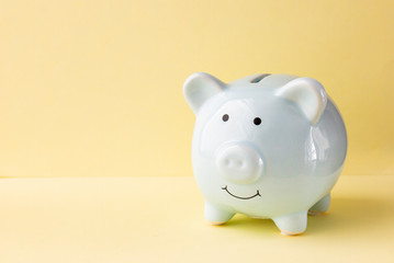 Piggy bank blue on a yellow background