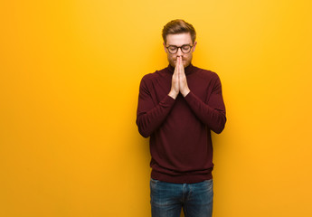 Young smart man praying very happy and confident