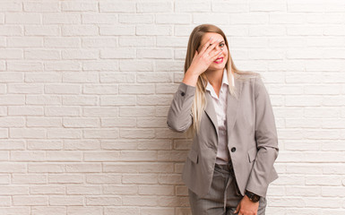 Young russian business woman person pointing by hand to a shirt copy space, proud and confident
