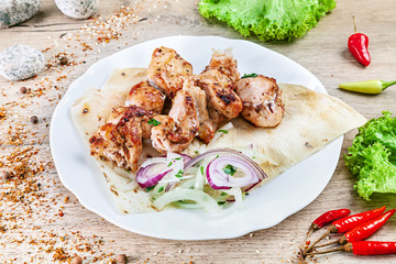 Close up view on served cooked on the grill chicken. shashlik or barbecue meat on pita. Shish kebab, traditional georgian cuisine food. Copy space for design