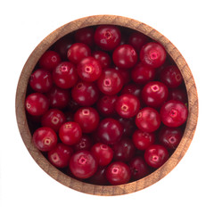fresh red cowberry in wooden cup isolated on white background. top view