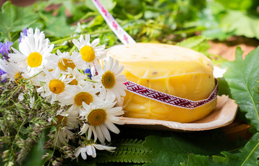 bouquet of daisies and cheese with fern and ribbon. symbolism of Latvia for Ligo holiday