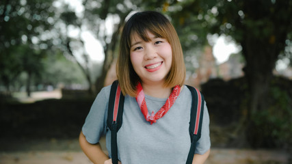 Traveler Asian woman feeling happy smiling to camera holiday trip at Ayutthaya, Thailand, backpacker female enjoy his journey at amazing landmark in traditional city. Lifestyle travel holidays concept