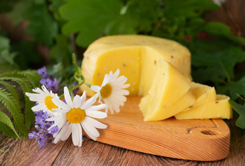 sliced cheese with cumin on a wooden table. Celebration of a traditional holiday in Latvia Ligo in...