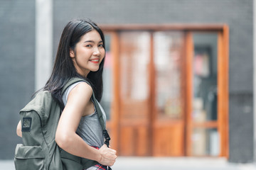 Fototapeta na wymiar Traveler Asian woman traveling and walking in Beijing, China, backpacker female feeling happy spending relax time in holiday trip. Lifestyle women travel in Asia city concept.