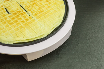 freshly baked waffle with waffle iron