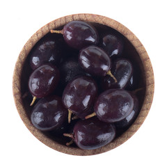 blue grapes in wooden cup isolated. top view