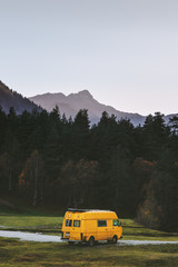 Travel van yellow camper road trip vacations in mountains summer family journey vanlife weekend...