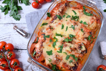 Roasted cabbage rolls with melted cheese in a glass baking dish. Russian cuisine meal