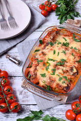 Roasted cabbage rolls with melted cheese in a glass baking dish. Russian cuisine meal
