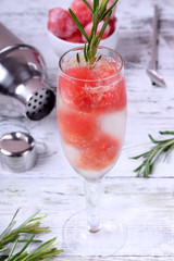 Sparkling cocktail with watermelon balls and rosemary in a champagne glass