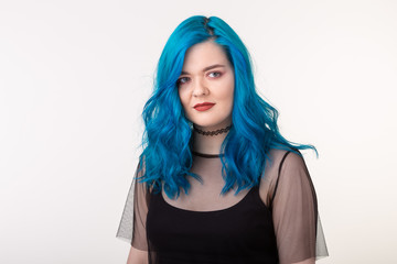 People and fashion concept - Beautiful woman with blue hair posing over white background