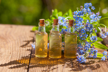 Essence of flowers on table in beautiful glass jar