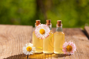 Essence of flowers on table in beautiful glass jar © solstizia