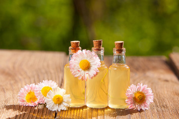 Essence of flowers on table in beautiful glass jar © solstizia