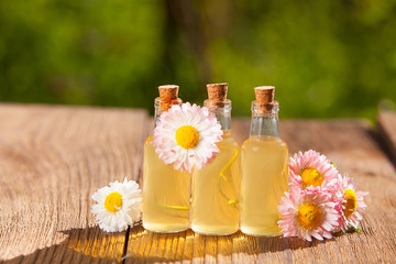 Essence of flowers on table in beautiful glass jar © solstizia