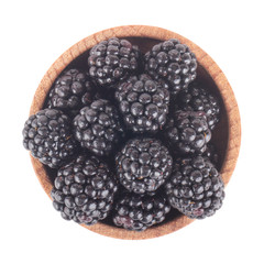 heap of blackberry in wooden cup isolated on white background