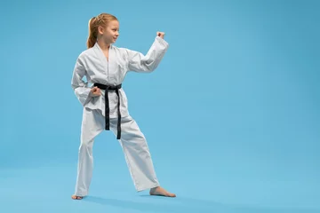 Gordijnen Girl in fighting stance of karate. Concept of martial arts. © serhiibobyk
