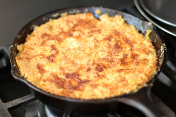 Peach cobbler in a cast iron skillet fresh out of the oven.