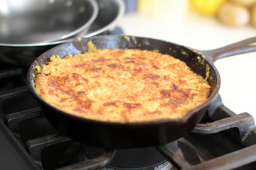 Peach cobbler in a cast iron skillet fresh out of the oven.
