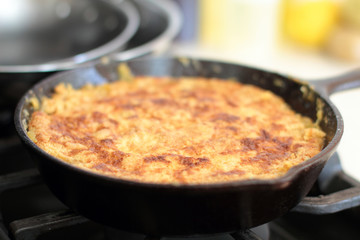 Peach cobbler in a cast iron skillet fresh out of the oven.