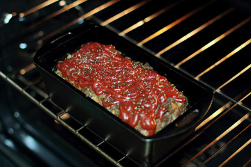 Homemade meatloaf baked in a cast iron loaf pan fresh out of the stove.