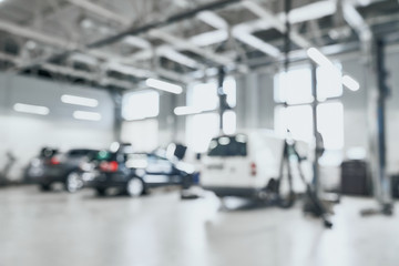 Abstract blur of spacious garage with three cars in one row