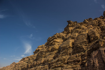 Naklejka premium desert sand stone rocky mountains photography foreshortening from below on blue sky background 