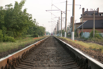 Fototapeta na wymiar Rails close-up from a low angle, passing in the city