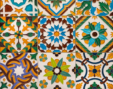 Ceramic colorful tiles on wall with traditional patterns. Arabic influence in spanish and portuguese artworks
