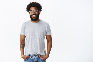 Friendly-looking satisfied and happy handsome african american boyfriend in glasses with pierced...
