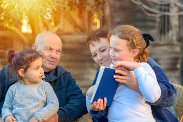 Happy Grandparents Enjoying Their Grand Children Outside.Family Portrait. Beautiful Happy Old...