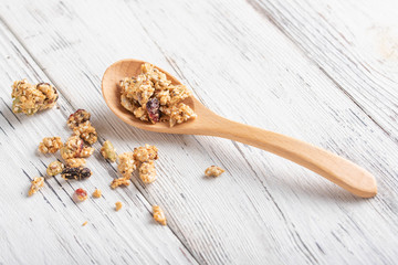 fruit and seed granola in wooden spoon
