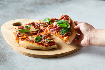 Pizza with ham and mushrooms on dark background