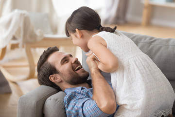 Happy dad and preschooler daughter have fun playing