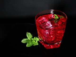 Strawberry, mint, ice, drink on a black background